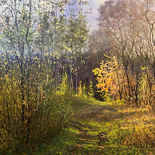 Fall landscape with yellow and orange leaves and a grassy oath through the center